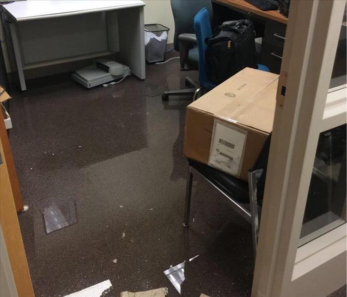 Flooded office space, standing water and debris