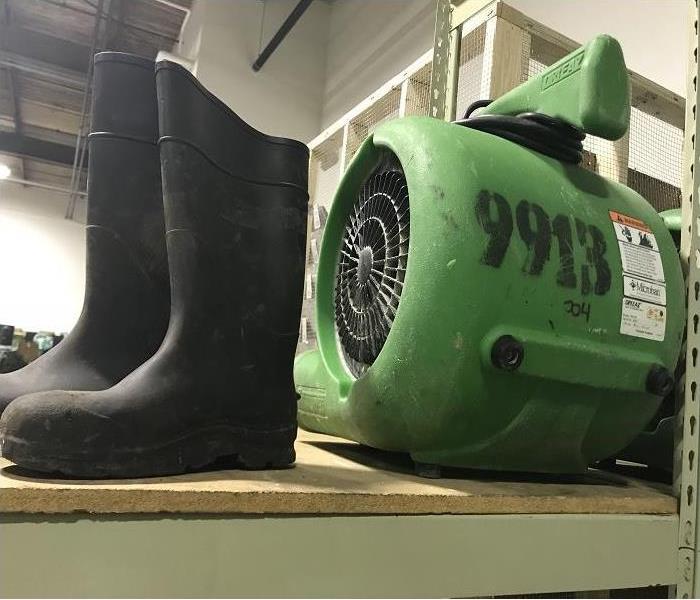 Rubber boots and SERVPRO green air dryer