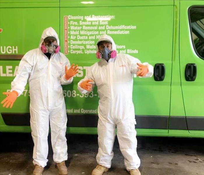 SERVPRO Production staff in full gear in front of SERVPRO van