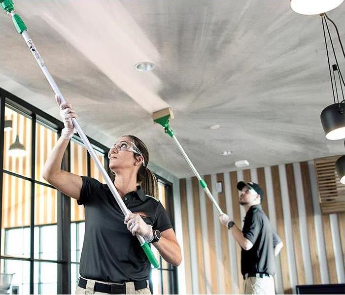 SERVPRO Professionals Cleaning up fire damage on a ceiling