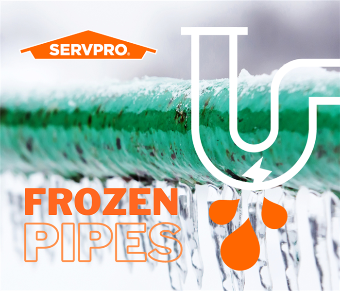 close up of green frozen pipe with orange words frozen pipes
