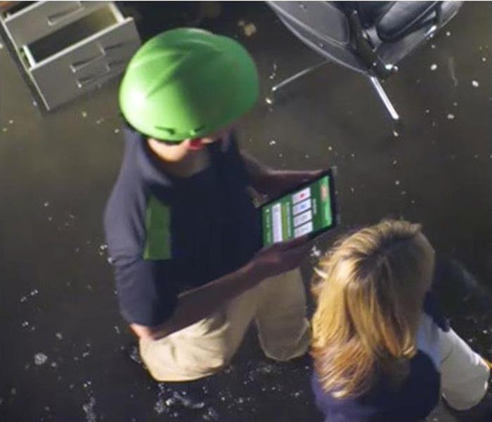 Two SERVPRO Techs inspecting a commercial space flood